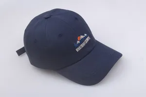 Detailed embroidery of mountains and sun with text on a navy blue cotton baseball cap