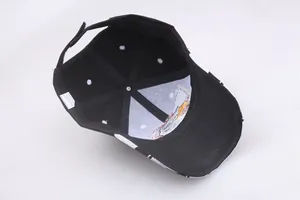 Detail of adjustable Velcro strap and internal lining on a black baseball cap