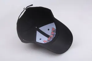 Detail view of the black cotton baseball cap interior showing embroidery and adjustable strap