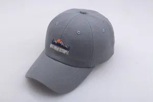 Close-up of grey baseball cap featuring mountain embroidery and Whatiwanissimple text
