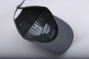 Detail view of dark gray baseball cap interior with adjustable metal buckle and stitching