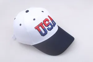 Detailed close-up of embroidered USA lettering on a white and blue cotton baseball cap