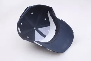 Detail view of the navy cotton baseball cap interior with white care label and inner structure