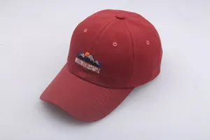 Detailed close-up of dark red baseball cap with mountain embroidery and white text