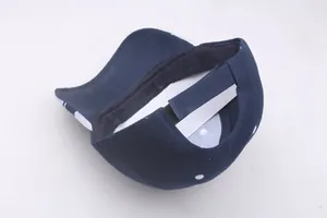 Detail of navy blue polka dot baseball cap showing adjustable velcro closure and stitching