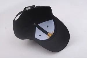 Interior view of black navy cap with gold embroidery logo and adjustable metal buckle