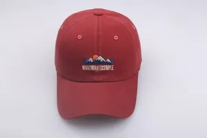 Detail of mountain embroidery and 'WHAT I WANT IS SIMPLE' text on burgundy baseball cap
