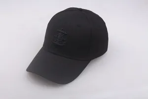 Close-up of black nautical cap featuring anchor embroidery and cotton twill texture