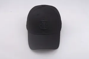 Close-up of nautical anchor and wheel embroidery on a black twill cotton sailor hat