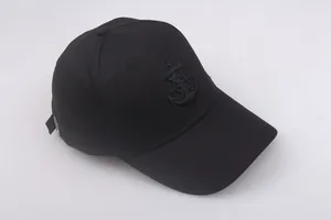 Detail of nautical anchor embroidery and metal buckle on black cotton navy cap