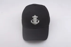 Detail of nautical anchor embroidery on the front of a black cotton sailor military cap