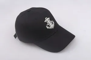 Detail of white nautical anchor embroidery on a black cotton captain sailor military cap