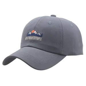 Grey cotton baseball cap with mountain embroidery and sun detail from 45-degree angle