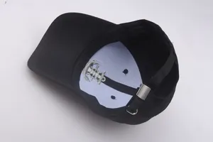 Detail of the black sailor hat interior featuring white support lining and anchor embroidery