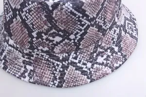 Detailed view of snakeskin print bucket hat showing fabric texture and brim stitching