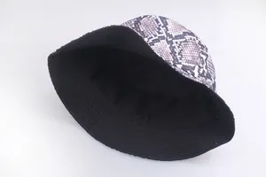 Trendy reversible bucket hat with purple snake print pattern and solid black inner lining