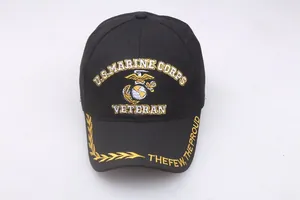 Close-up of yellow embroidered US Marine Corps logo and Veteran text on black cotton cap