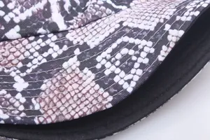 Double-sided snakeskin print bucket hat with triple-stitch brim and black lining fabric
