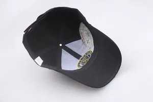 Detailed interior of black baseball cap with six-panel construction and USA eagle patch