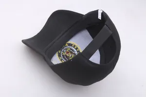 Macro view of eagle embroidery patch and care label inside a black baseball cap