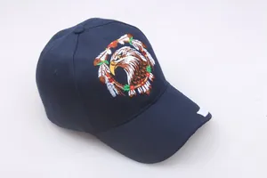 Detail showing the intricate eagle head embroidery on a navy blue cotton baseball cap