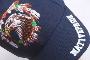 Macro view of detailed eagle embroidery and Native Pride text on blue cotton baseball cap