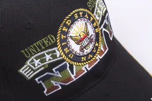 Close-up of United States Navy eagle and anchor embroidery on a black baseball cap