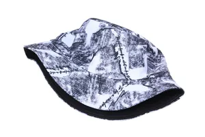 Detailed view of bucket hat with monochrome graffiti print and black edge piping