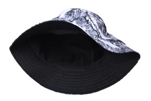Reversible bucket hat with retro mountain print and artistic script in black and white