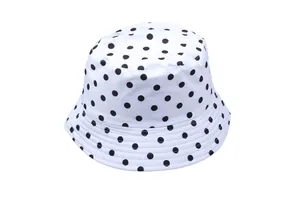 Detail of high-density canvas sun hat featuring black polka dots and reinforced stitching