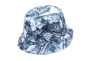 Detail of blue and white tie-dye bucket hat featuring black graffiti print and stitching