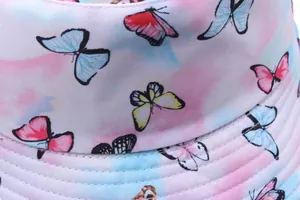Detailed close-up of tie-dye bucket hat featuring colorful butterfly prints and stitching