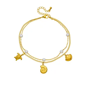 Gold-plated double-layer anklet featuring sea turtle, scallop, and nautilus shell charms