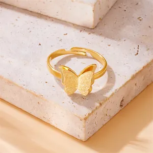 Detailed view of a gold-plated butterfly ring with sparkling textured wings on stone