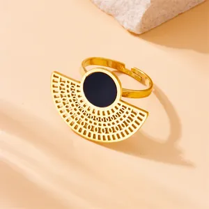 Detailed shot of gold stainless steel open ring with black fan-shaped hollow design