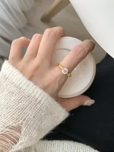Macro view of gold bamboo texture ring featuring a sparkling round solitaire diamond