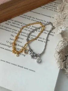 Detail of S925 silver beaded bracelets with zircon flower and oval stone charms