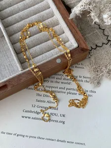 Detailed close-up of multi-layer gold S925 silver chains with tiny heart pendant stamp
