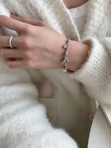 Close-up of S925 sterling silver beaded bracelet and pavé ring set on model's wrist