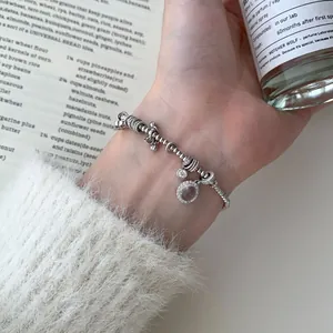 Elegant S925 sterling silver beaded bracelet with sparkling charms on a female wrist