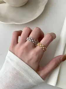 Close-up of woven S925 sterling silver lace rings with micro-pave crystals for women