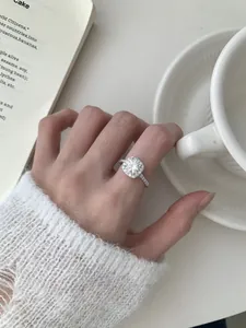 Macro shot of silver halo ring with round center stone and pave setting details