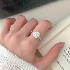 Luxurious S925 silver halo ring with round moissanite stone and pave band on hand