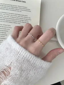Detail of stacked gold and silver S925 sterling silver rings with micro-pave zircons