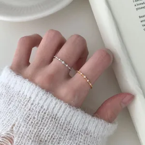 Elegant wave-textured S925 silver rings with micro-set diamonds shown on a hand