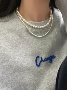 Close-up of double-layer S925 silver necklace with premium round cream white pearls