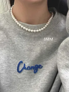 Close-up of a premium 8mm round white pearl necklace on a model for a daily look