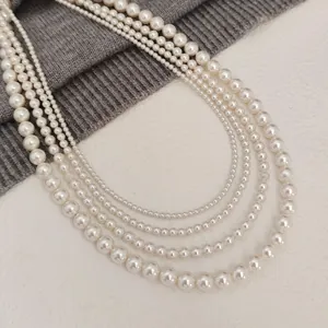 Elegant five-layer S925 silver round pearl necklace with high luster on grey knitwear