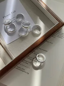 Detailed close-up of matte S925 sterling silver rings with hallmarked interior and texture