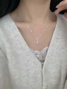 Close-up of S925 silver bow necklace with waterdrop zircon on a woman's neck